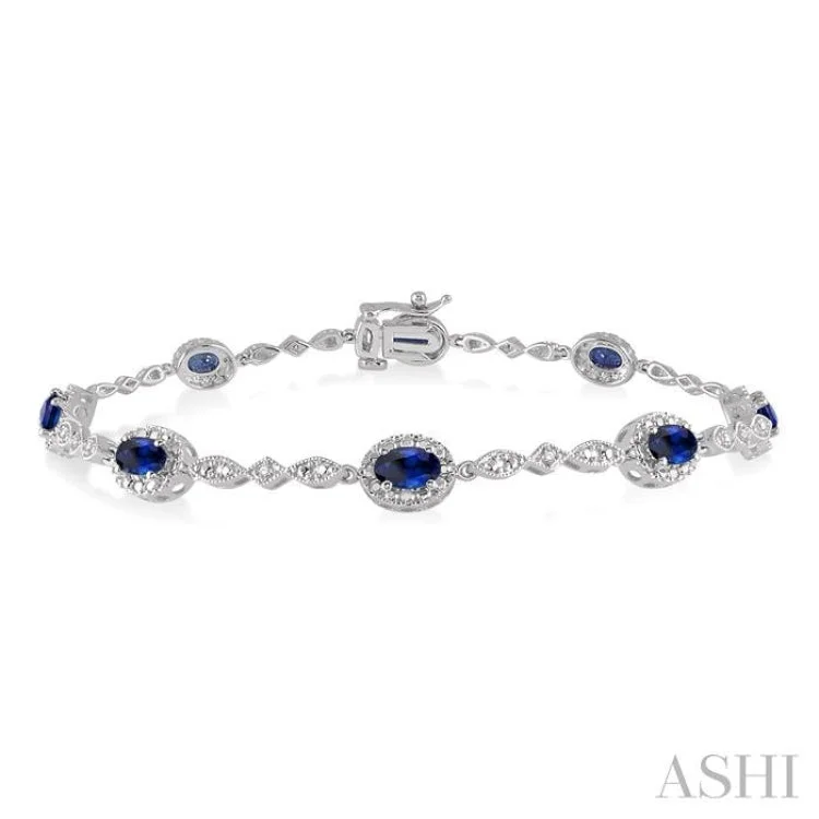 5x3MM Oval Cut Sapphire and 1/20 Ctw Single Cut Diamond Bracelet in 14K White Gold